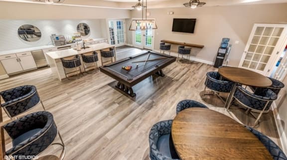 a game room with a pool table and chairs at Brittany Commons Apartments, Spotsylvania, VA, 22553